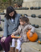 little girl and her pumpkin crop